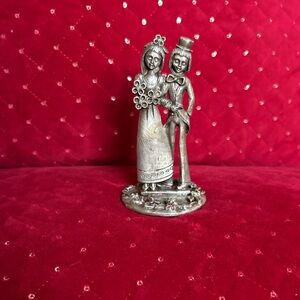This is a vintage Italian Peltro pewter bride and groom figurine.